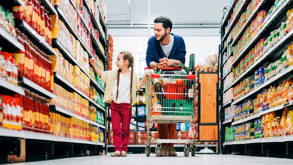 Case Study: Adoption of E-Commerce and Delivery Apps - Cargills Food City. father and daughter with trolley in supermarket aisle